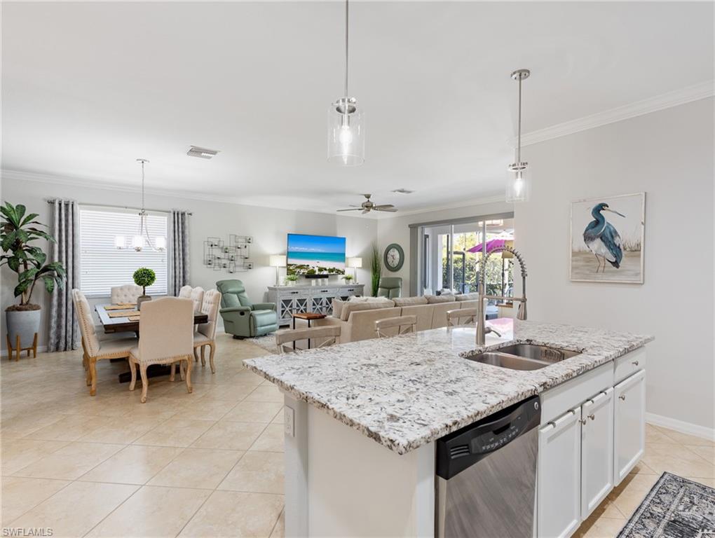 21116 Bella Terra Boulevard Estero, FL 33928 - Photo 19 of 49 a kitchen with granite countertop a table and chairs in it