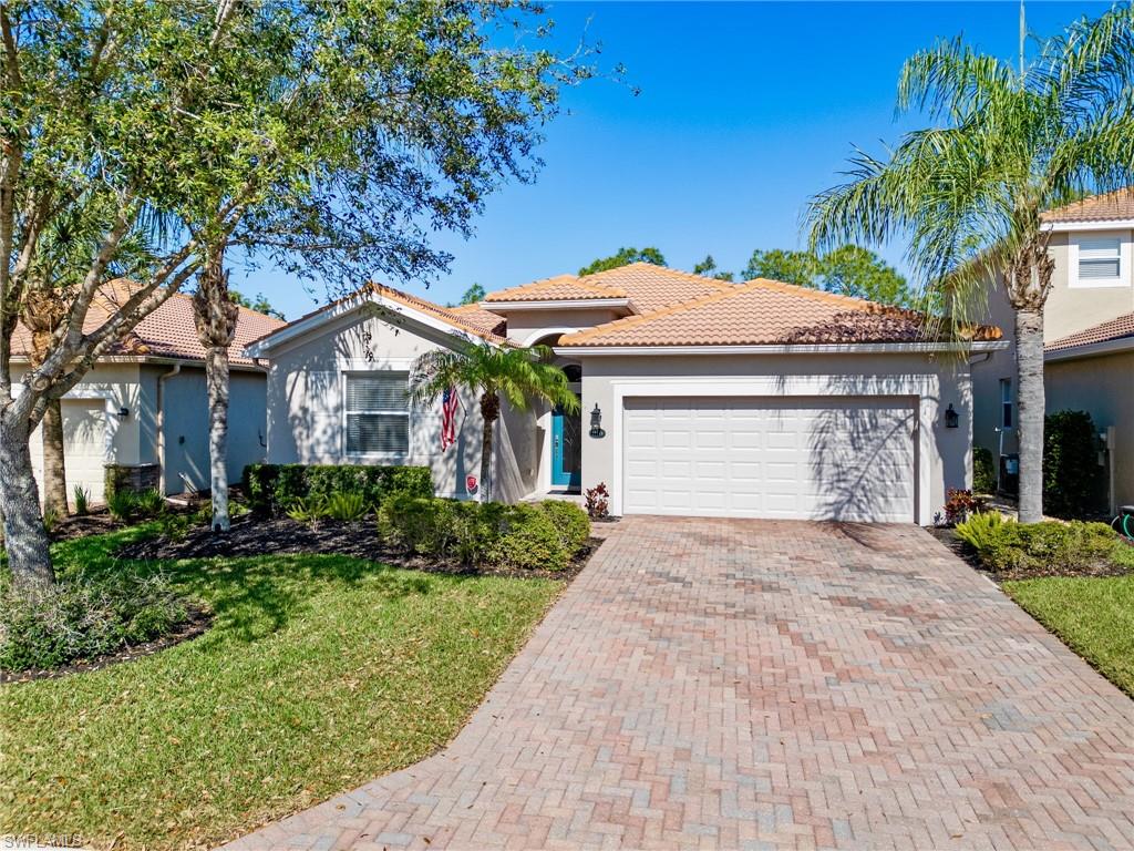 21116 Bella Terra Boulevard Estero, FL 33928 - Photo 2 of 49 a front view of a house with a garden