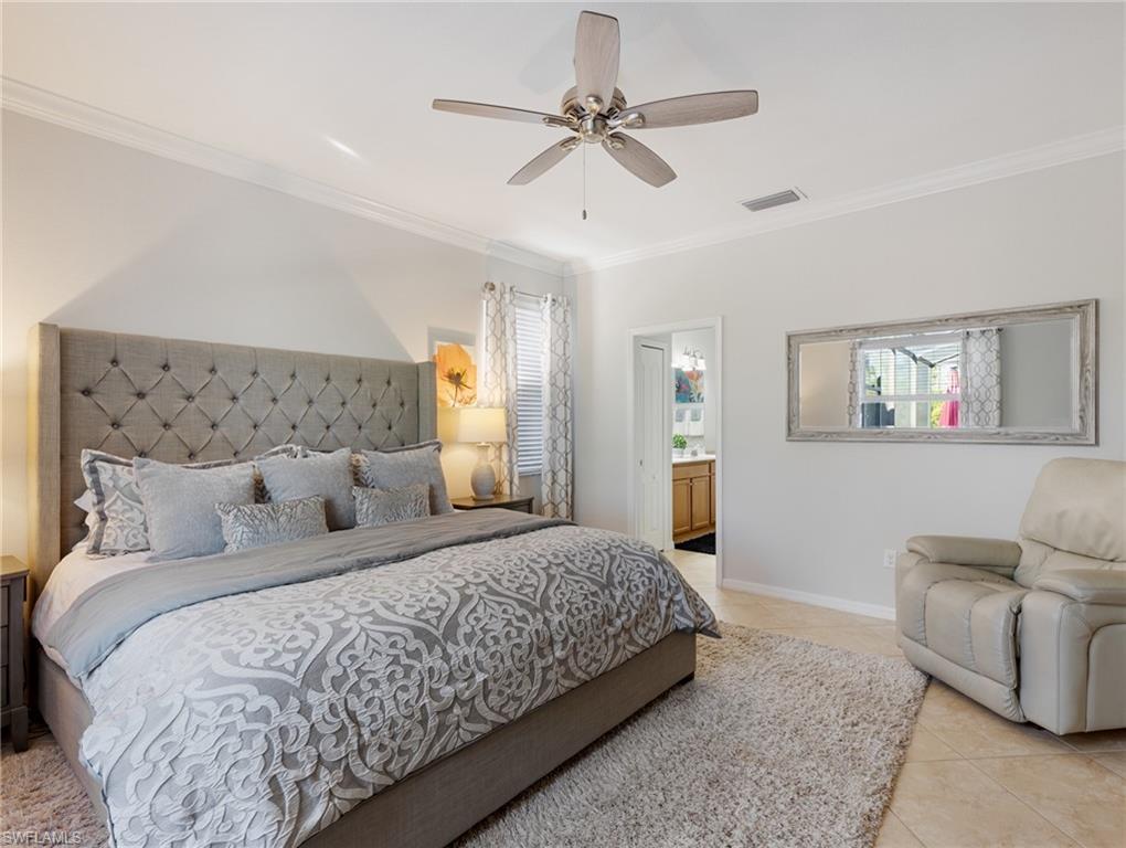 21116 Bella Terra Boulevard Estero, FL 33928 - Photo 21 of 49 a bedroom with a large bed a couch and a chandelier