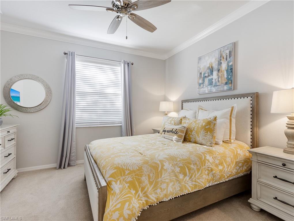 21116 Bella Terra Boulevard Estero, FL 33928 - Photo 25 of 49 a bedroom with a bed and a chandelier