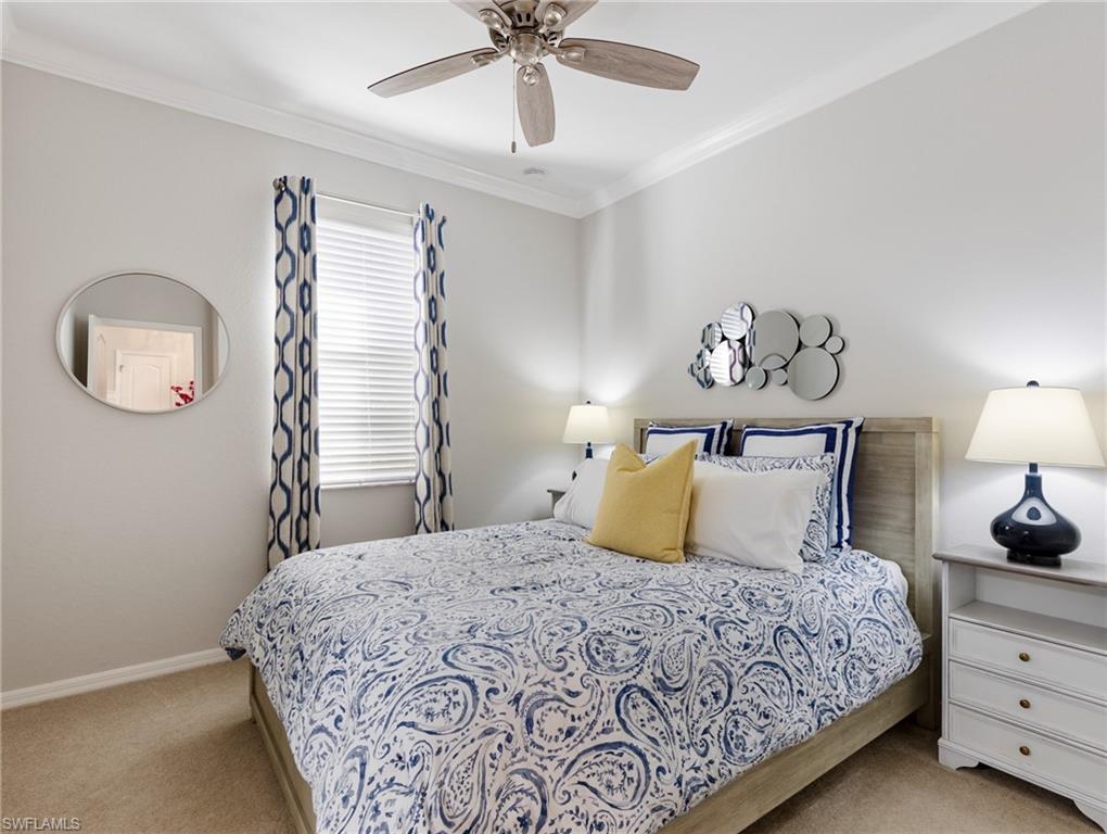 21116 Bella Terra Boulevard Estero, FL 33928 - Photo 27 of 49 a bedroom with a bed and a chandelier