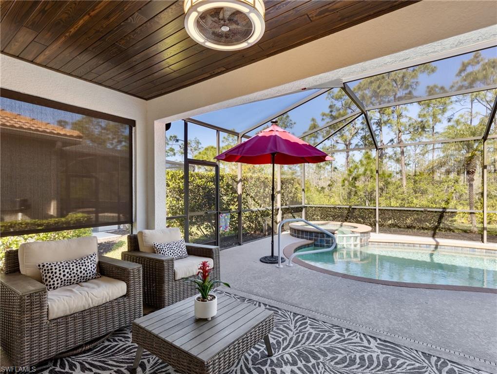 21116 Bella Terra Boulevard Estero, FL 33928 - Photo 31 of 49 a living room with furniture and a floor to ceiling window