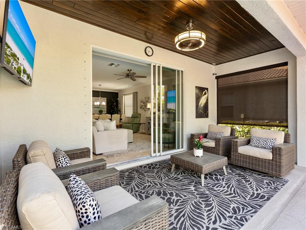 21116 Bella Terra Boulevard Estero, FL 33928 - Photo 32 of 49 a living room with furniture and a flat screen tv