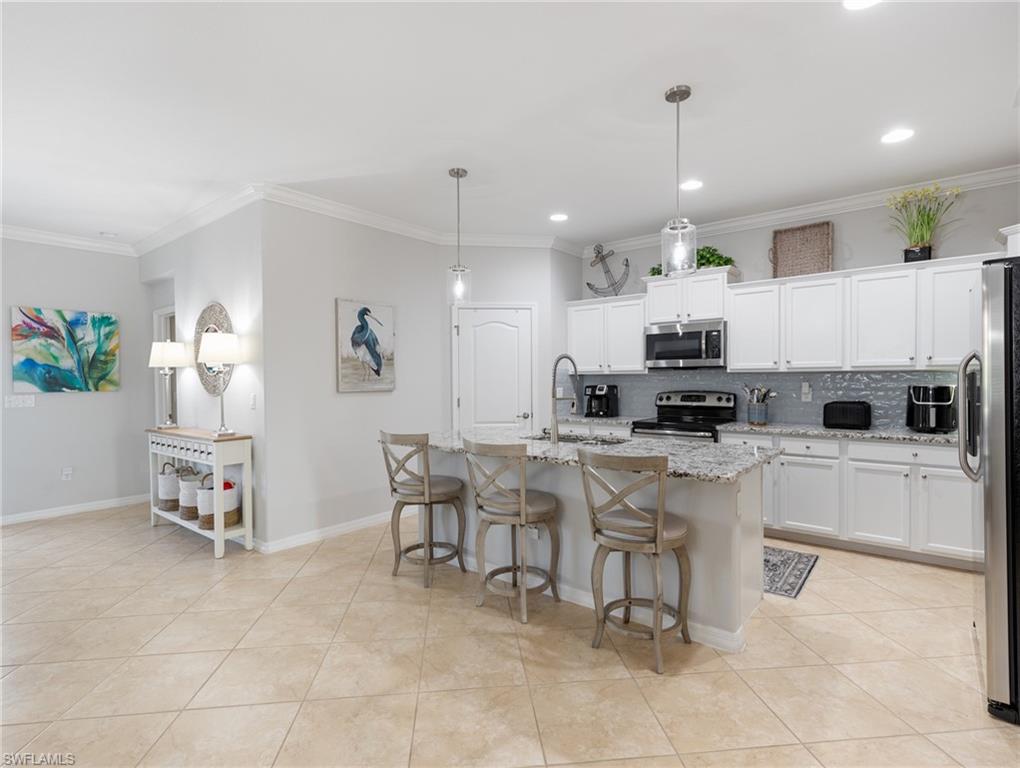 21116 Bella Terra Boulevard Estero, FL 33928 - Photo 6 of 49 a kitchen with a sink a counter top space appliances and cabinets