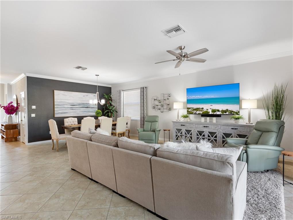 21116 Bella Terra Boulevard Estero, FL 33928 - Photo 10 of 49 a living room with furniture a fireplace and a chandelier