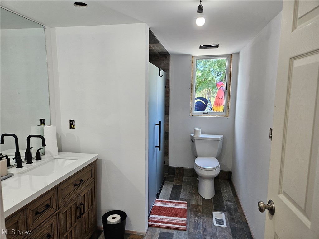 1180 North County Line Road Geneva, OH 44041 - Photo 17 of 33 Bathroom with vanity and wood finished floors