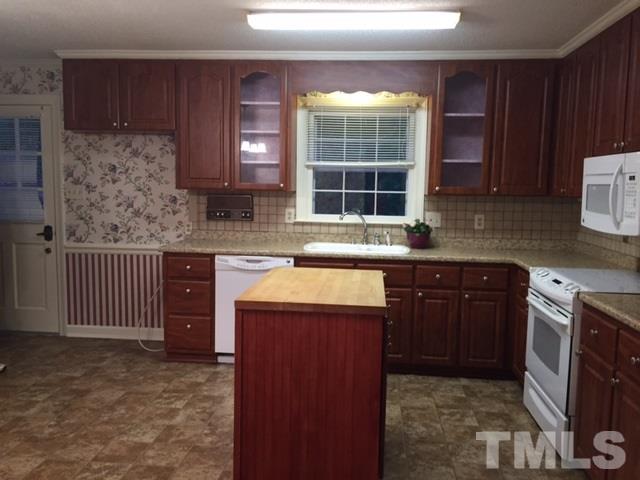 1308 Knights Way Raleigh, NC 27615 - Photo 15 of 25 a kitchen with stainless steel appliances granite countertop a stove a sink and a microwave