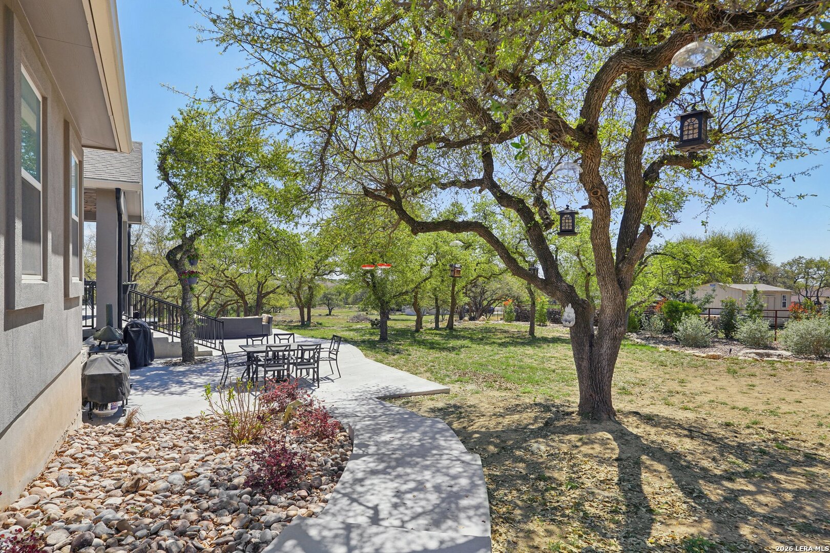 234 Sabella Spring Branch, TX 78070 - Photo 33 of 39 a view of a backyard with table and chairs and a large tree