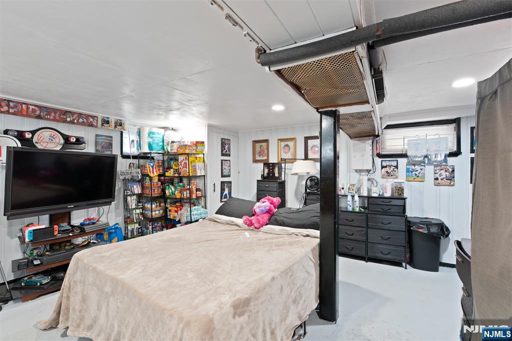 276 East 26th Street Paterson, NJ 07514 - Photo 13 of 30 a bed room with a bed and a flat screen tv