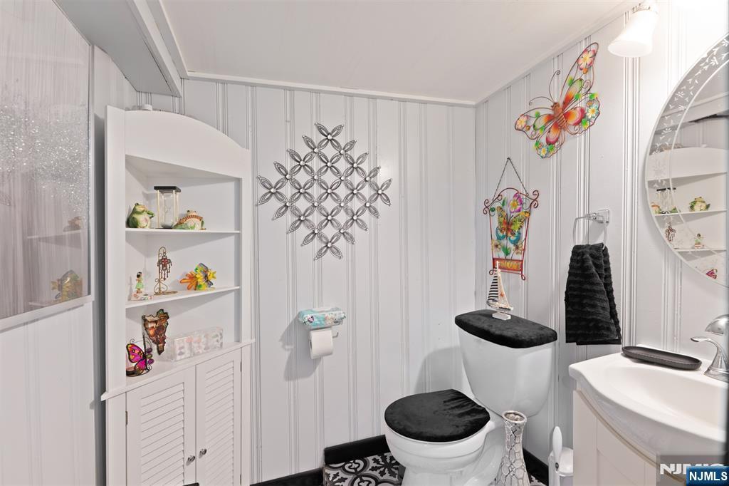 276 East 26th Street Paterson, NJ 07514 - Photo 16 of 30 a bathroom with a sink mirror and toilet