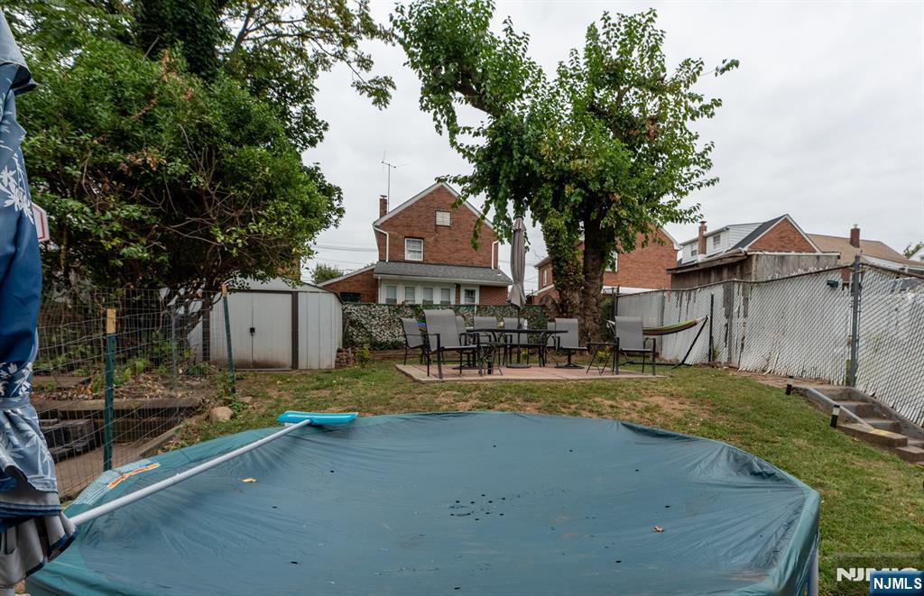 276 East 26th Street Paterson, NJ 07514 - Photo 24 of 30 a view of a house with large tree next to a yard
