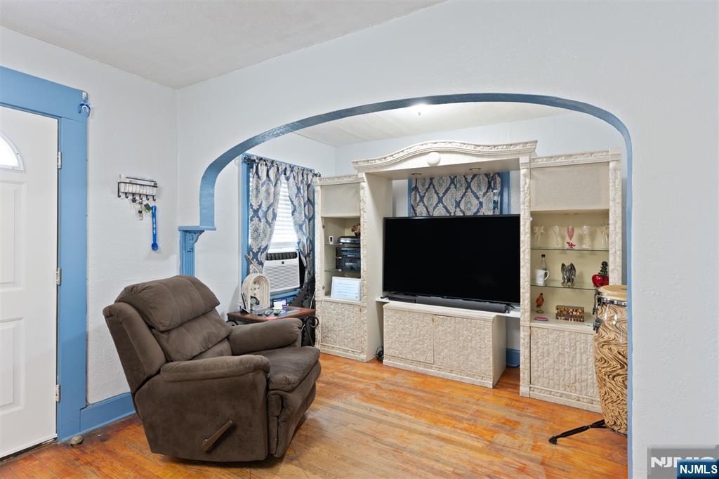 276 East 26th Street Paterson, NJ 07514 - Photo 4 of 30 a living room with furniture and a flat screen tv