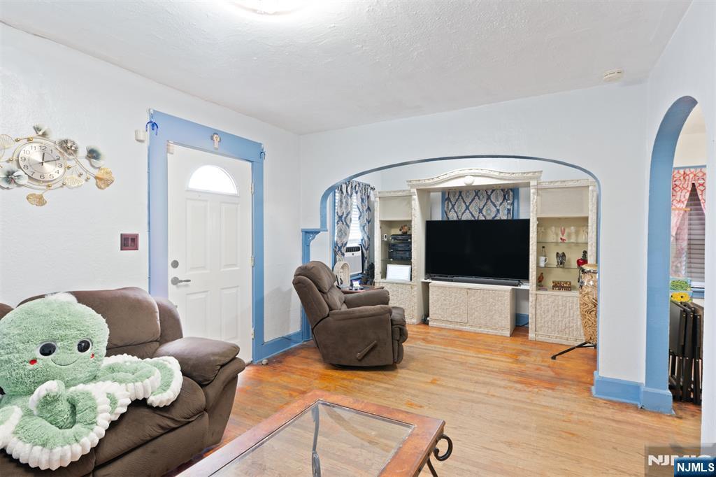 276 East 26th Street Paterson, NJ 07514 - Photo 6 of 30 a living room with furniture and a flat screen tv