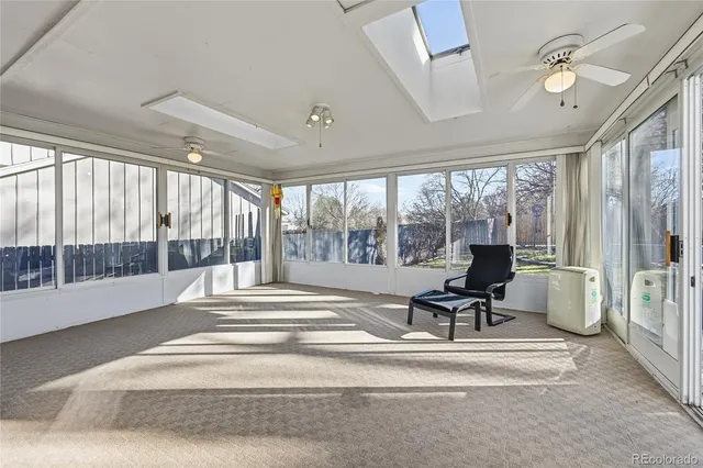 a living room with furniture and large windows