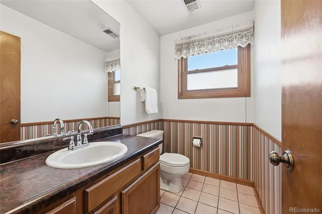a bathroom with a sink a toilet and mirror