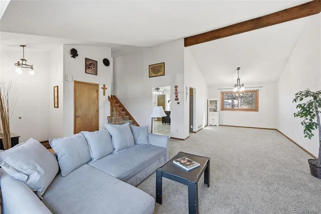 a living room with furniture and a ceiling fan