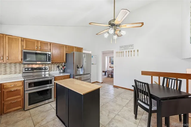 a kitchen with cabinets a sink and stainless steel appliances