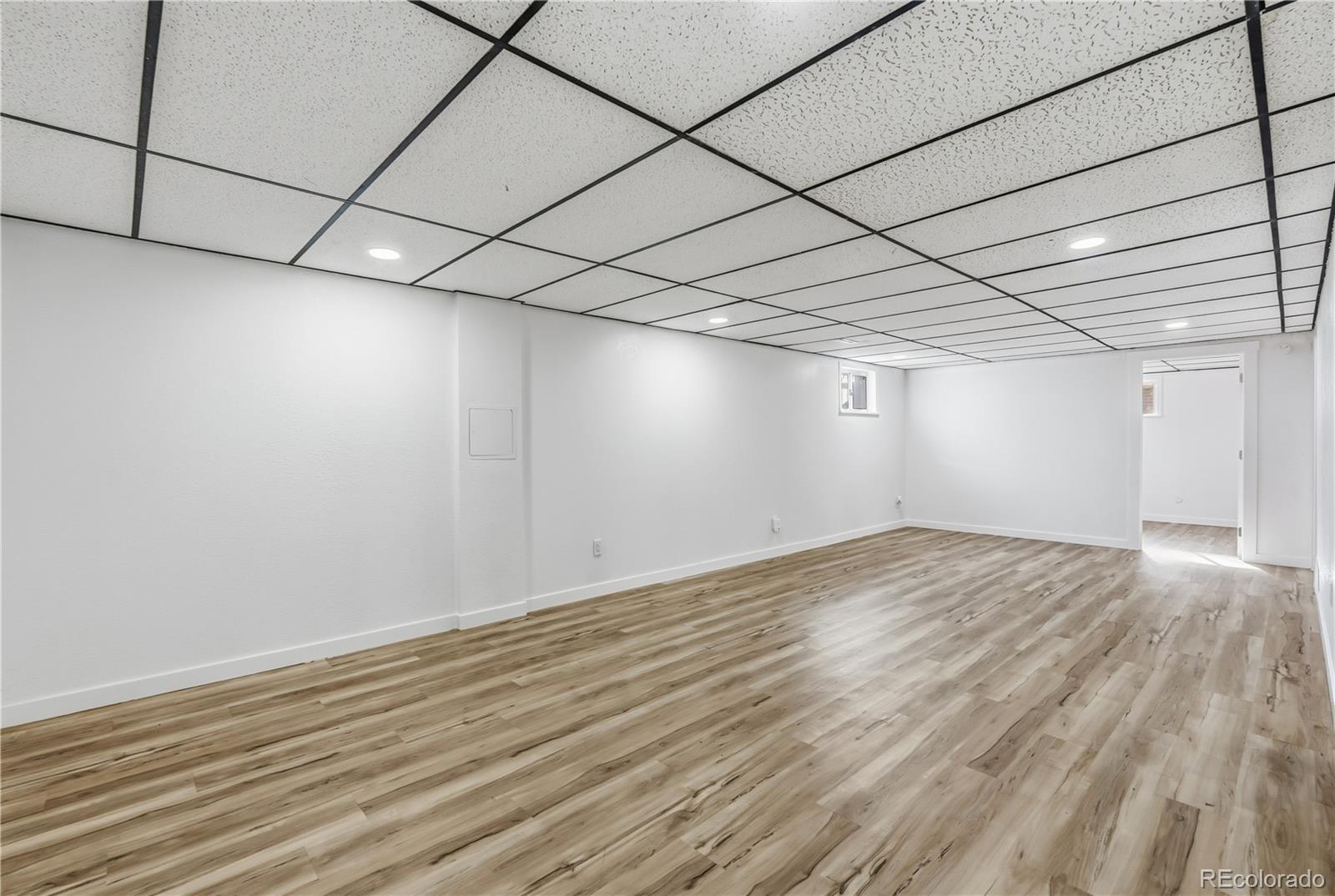 8331 Ogden Street Denver, CO 80229 - Photo 12 of 23 a view of a room with wooden floor