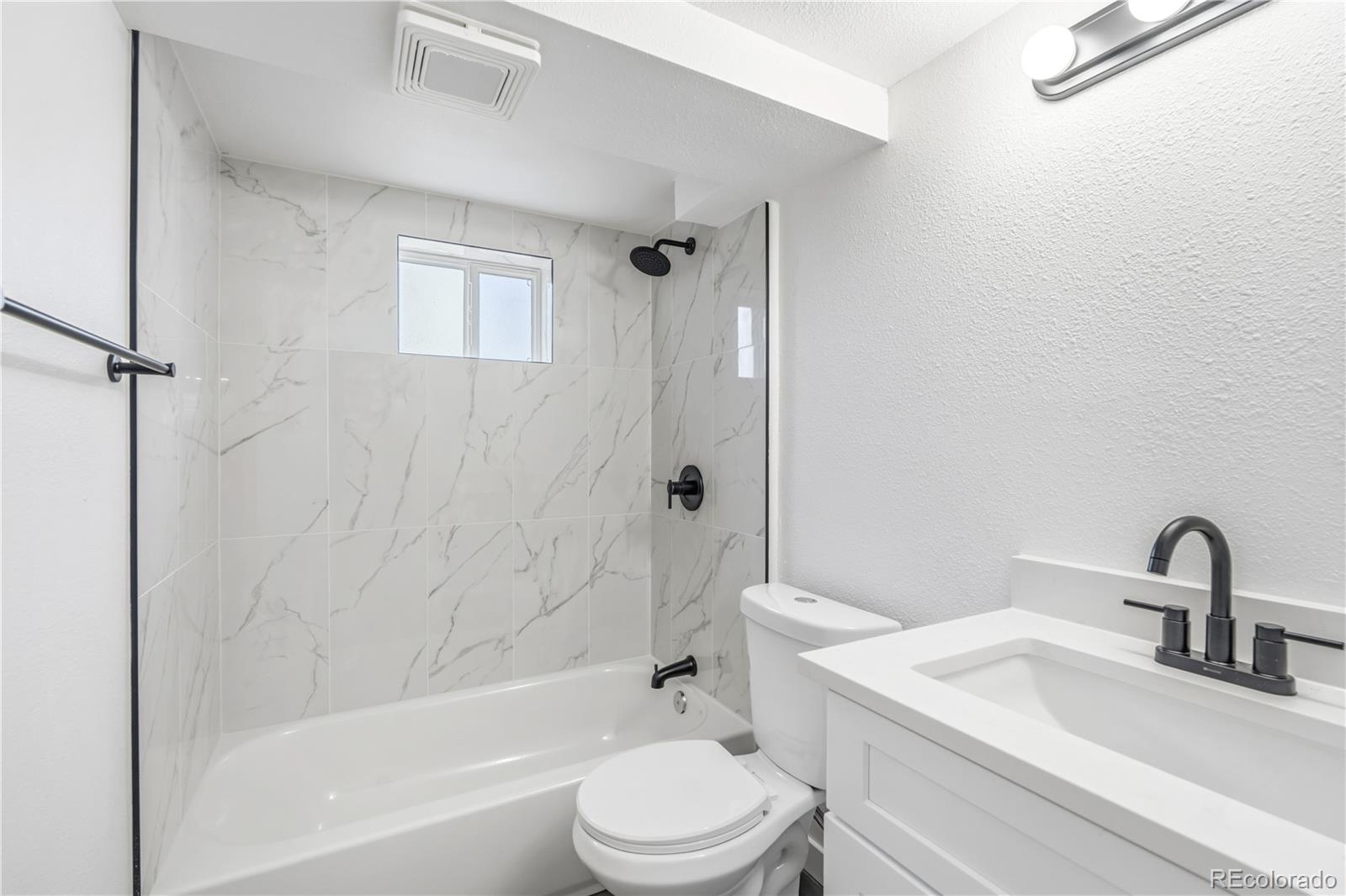 8331 Ogden Street Denver, CO 80229 - Photo 15 of 23 a bathroom with a sink toilet and a bathtub