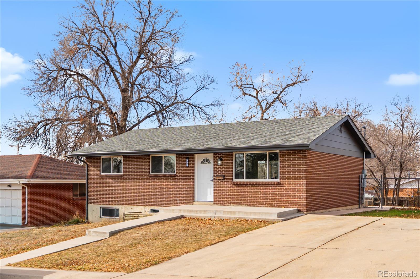 8331 Ogden Street Denver, CO 80229 - Photo 16 of 23 a front view of a house with a yard
