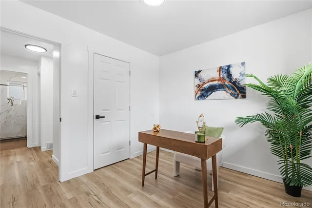 an empty room with wooden floor and window