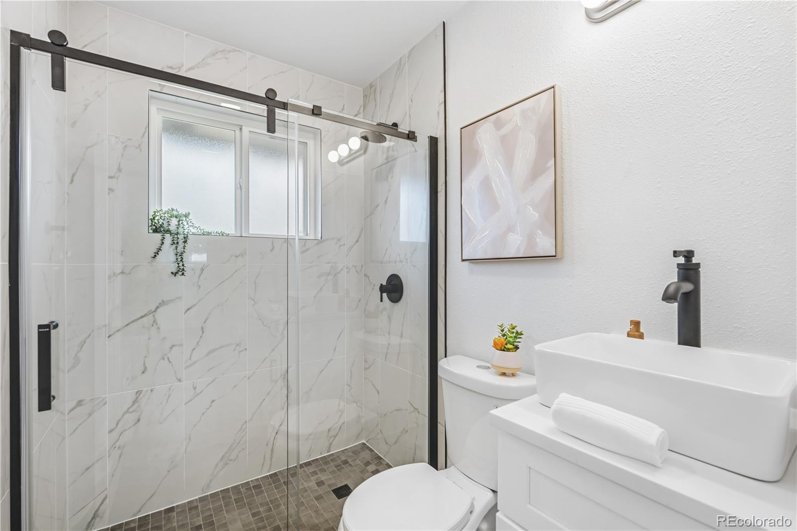 8331 Ogden Street Denver, CO 80229 - Photo 10 of 23 a bathroom with a sink toilet and shower