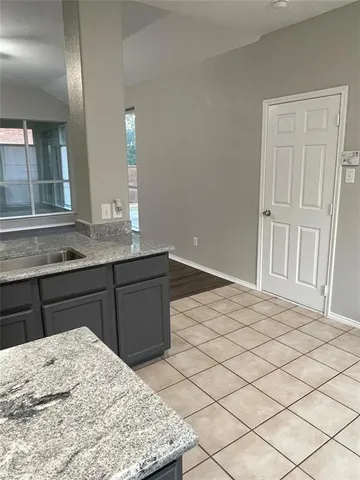 a kitchen with a sink refrigerator and cabinets
