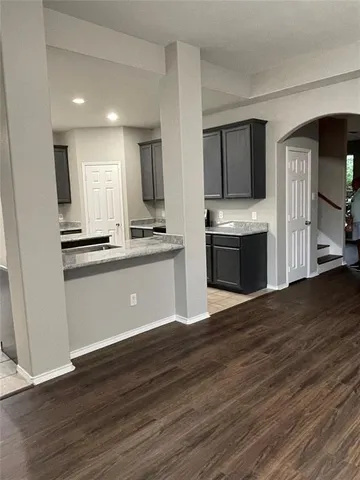 a kitchen with stainless steel appliances granite countertop a sink a stove and refrigerator