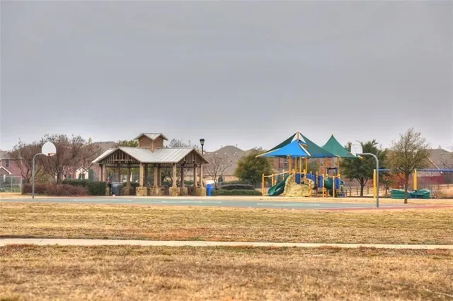 a view of large and white house with a swimming pool and trees in the background