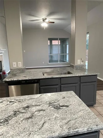 a kitchen with a stove and a sink