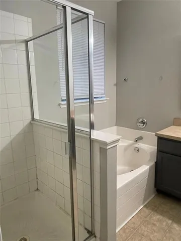 a bathroom with a bathtub and a shower