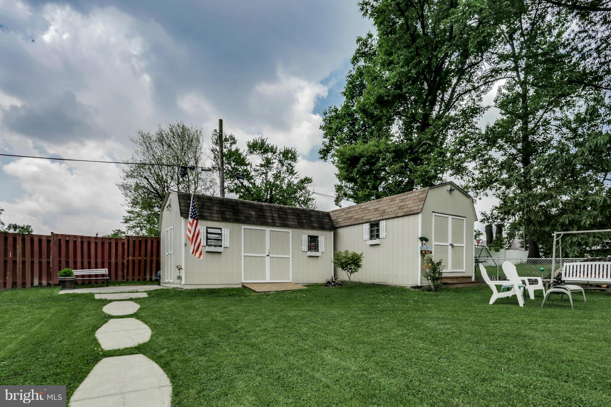 449 West Maple Road Linthicum Heights, MD 21090 - Photo 21 of 30 a view of a white house with a big yard and a large tree