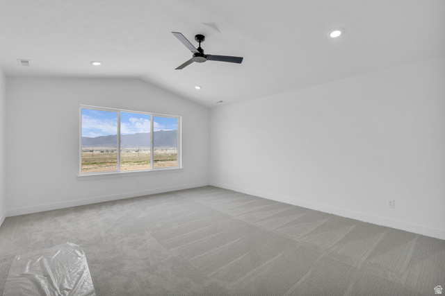 2821 Scarlet Road, Unit 149 Eagle Mountain, UT 84005 - Photo 22 of 28 Vaulted primary bedroom featuring a three-panel large window with a mountain backdrop, LED lighting, contemporary ceiling fan.