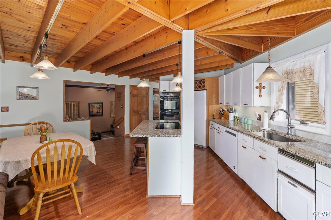 81 Palmer Road Bangor, PA 18013 - Photo 35 of 50 a large kitchen with a table chairs wooden floor and a sink