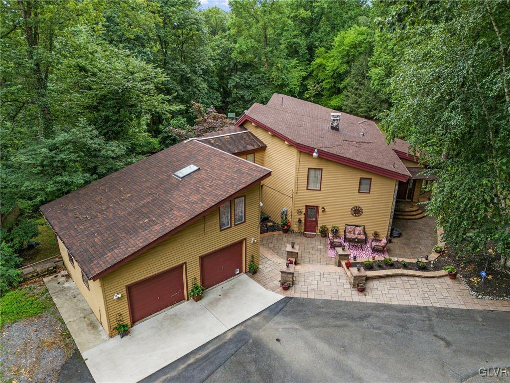 81 Palmer Road Bangor, PA 18013 - Photo 7 of 50 a aerial view of a house with table and chairs under an umbrella