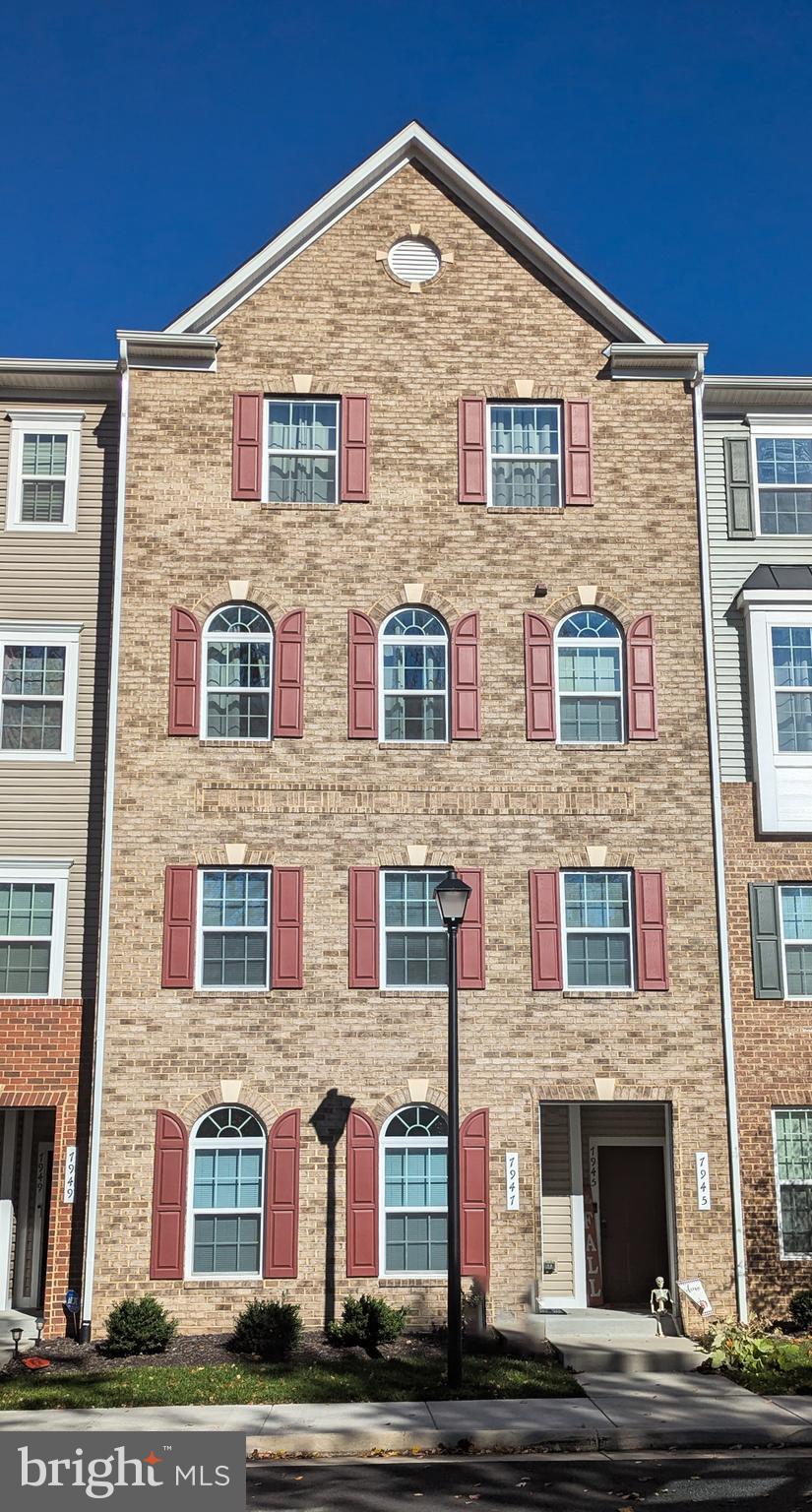 a front view of brick house with windows