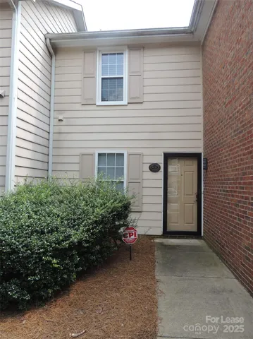 a view of a house with potted plants
