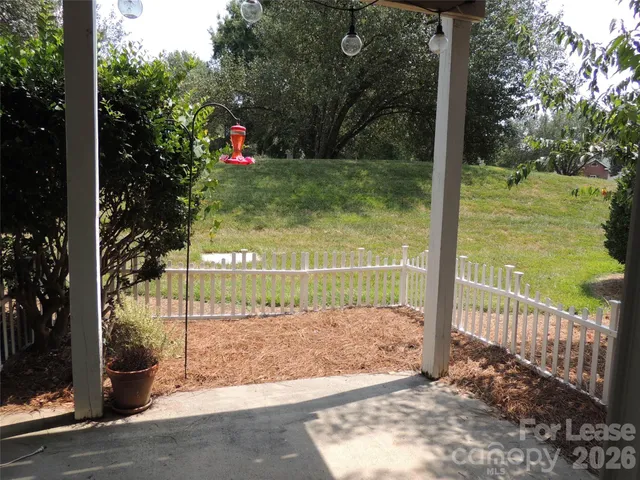 a view of a park with iron fence