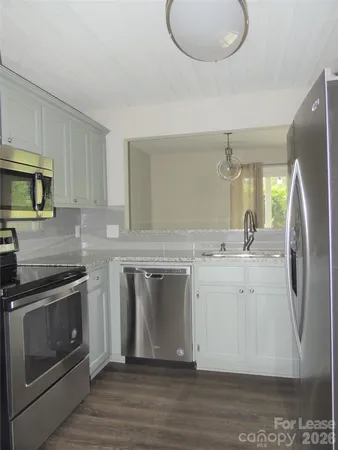 a kitchen with a sink stove and refrigerator