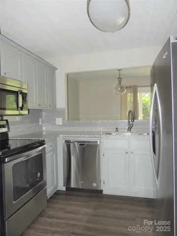 a kitchen with a sink stove and refrigerator