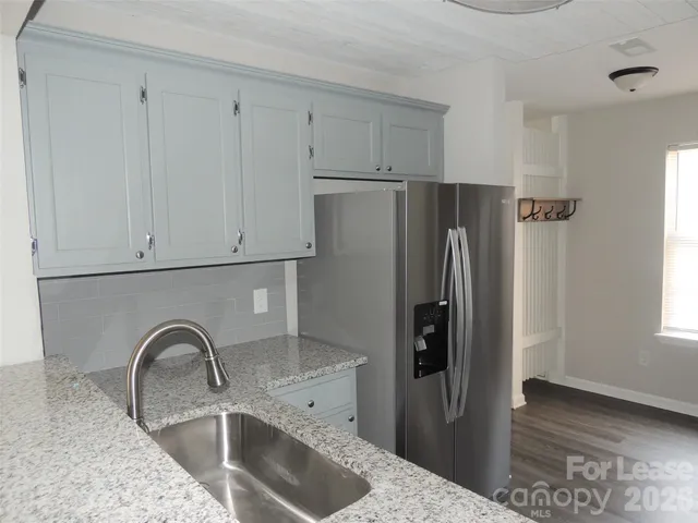 a close view of a kitchen sink and cabinets