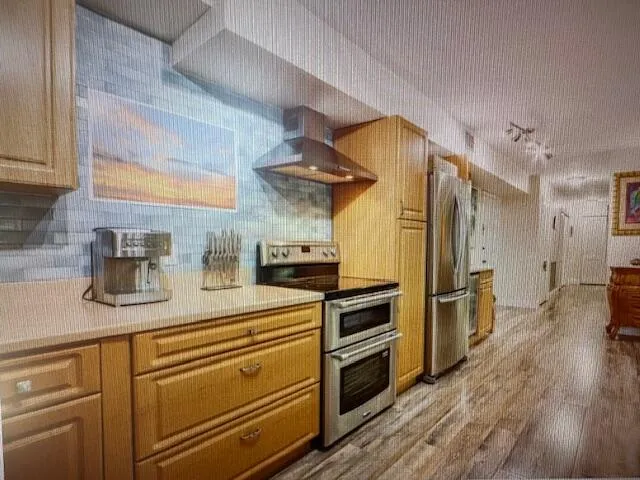 a kitchen with a refrigerator and cabinets