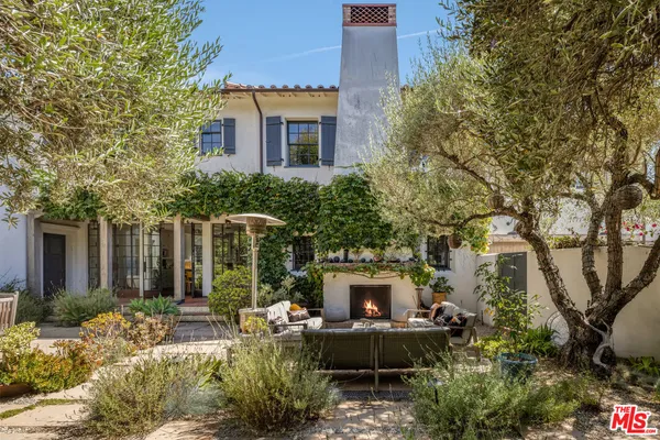 a backyard of a house with outdoor seating