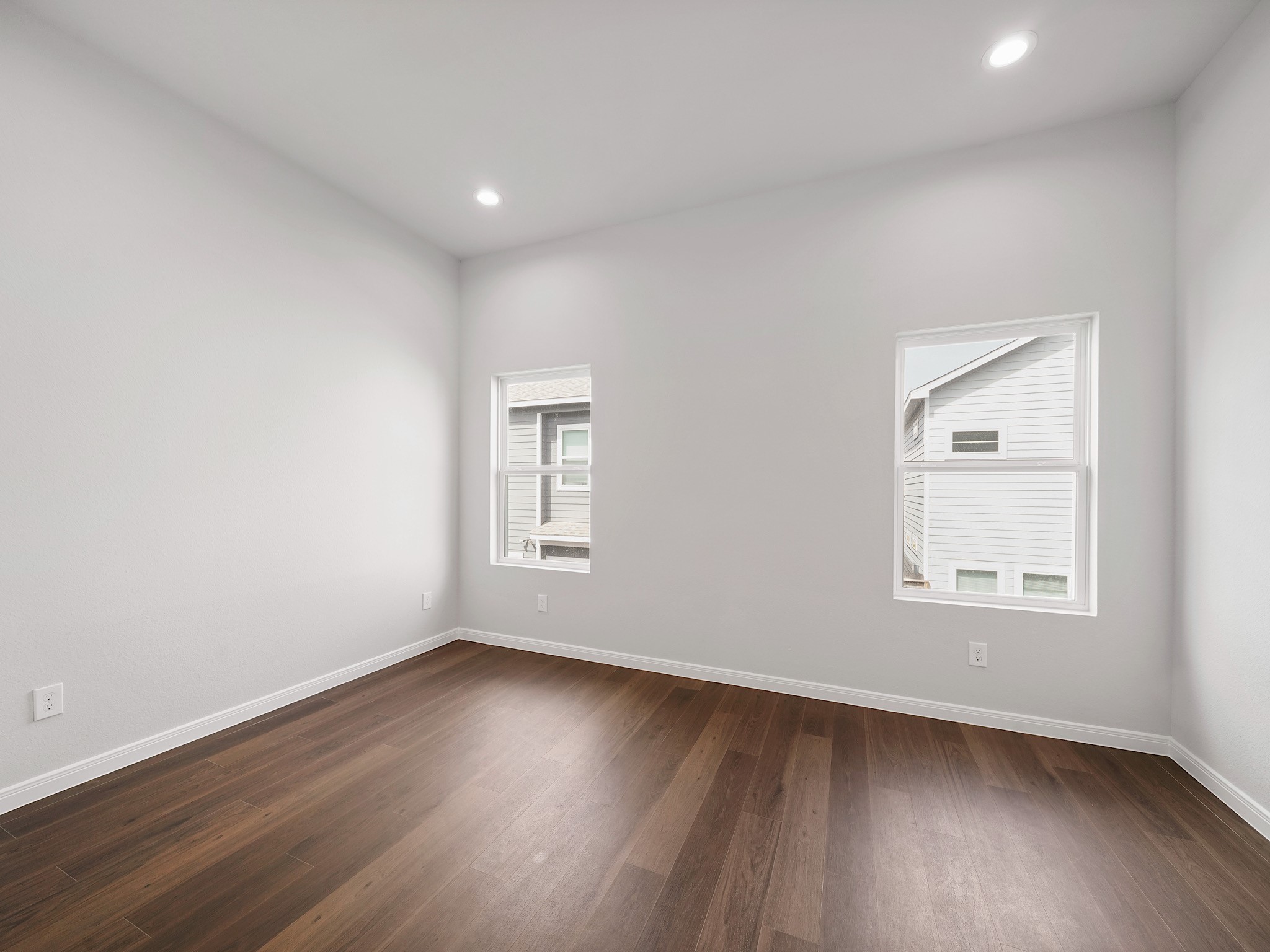 18846 Elegance Ave Spring Spring, TX 77379 - Photo 12 of 16 an empty room with wooden floor and windows