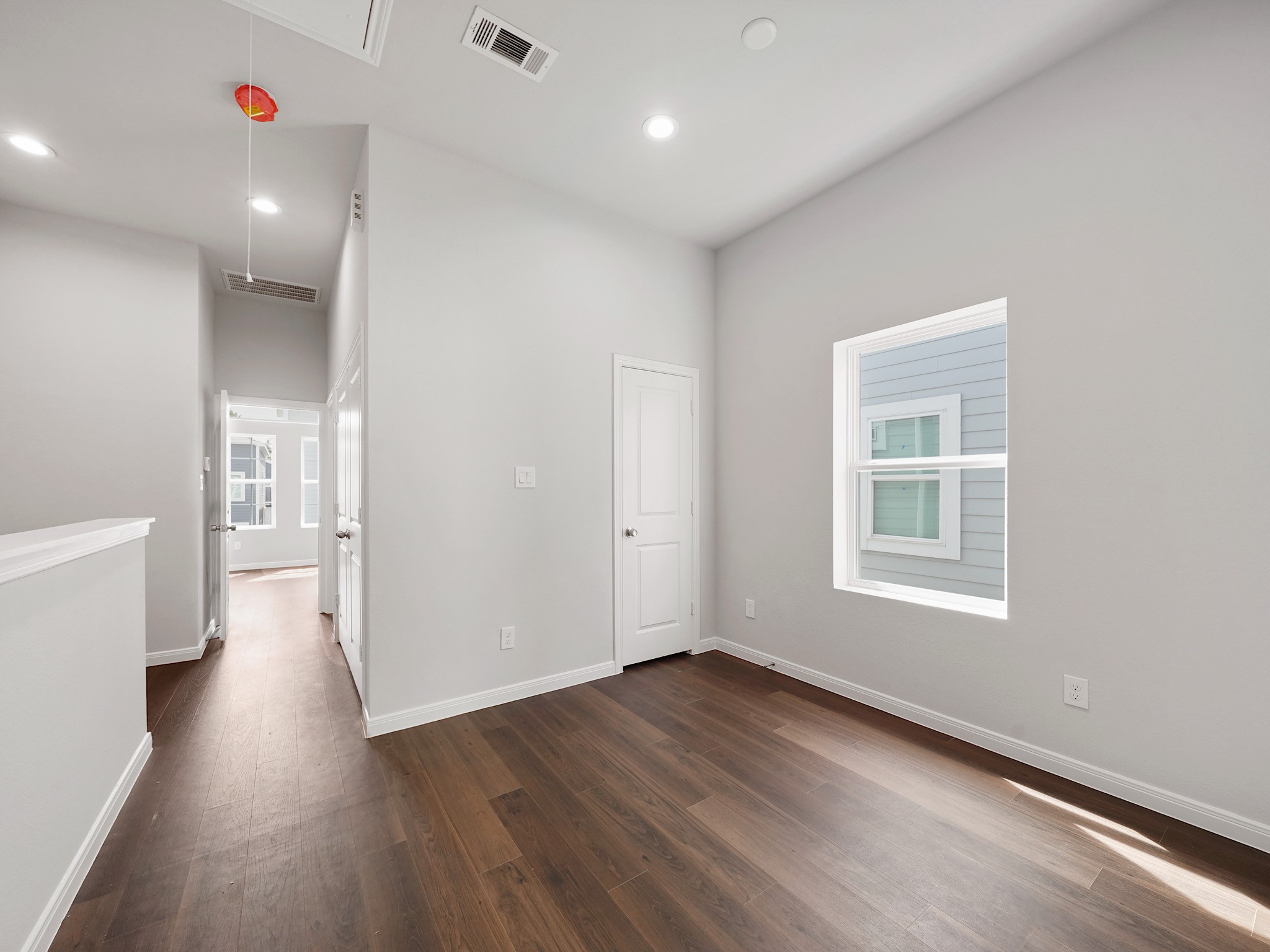 18846 Elegance Ave Spring Spring, TX 77379 - Photo 13 of 16 an empty room with wooden floor and windows