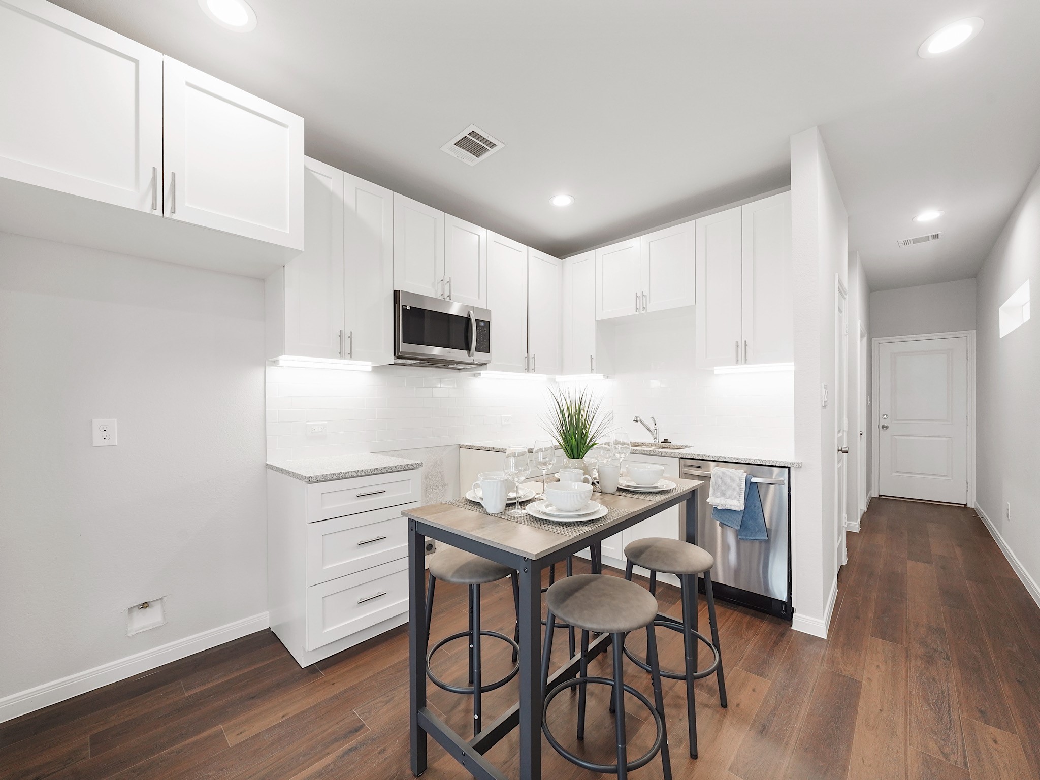 18846 Elegance Ave Spring Spring, TX 77379 - Photo 3 of 16 a kitchen with stainless steel appliances kitchen island granite countertop a sink dishwasher a stove a refrigerator with a dining table and chairs