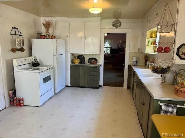 a kitchen with refrigerator and cabinets