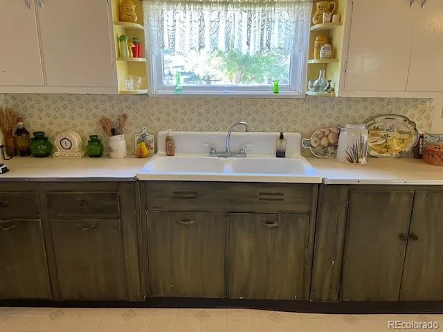 a kitchen with a refrigerator and a stove