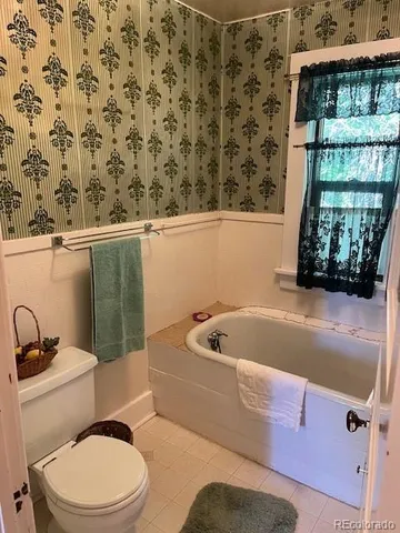 a bathroom with a sink toilet and mirror