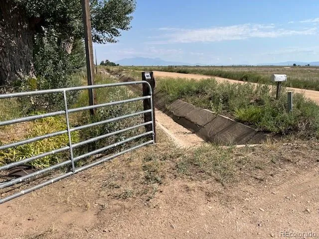 a view of a yard with wooden fence
